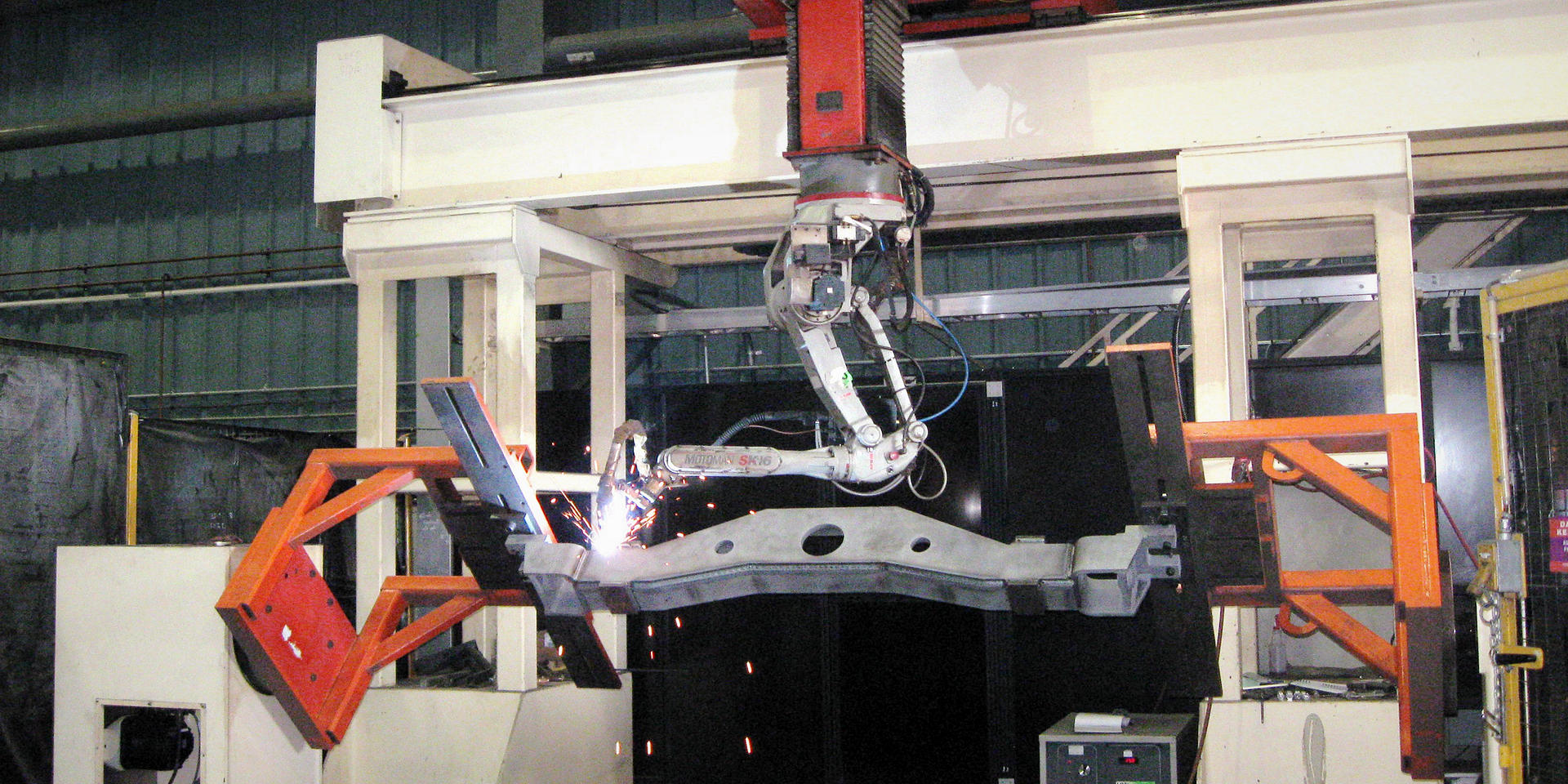 Steering beam being welded by large welding robot at Piper Lane location.