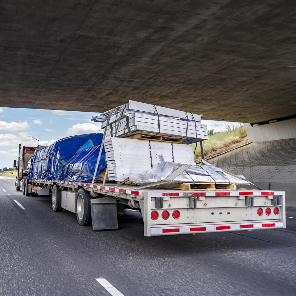 18-wheeler truck and trailer on a highway. Trucking themed stock image licensed to ADJ Industries Inc.