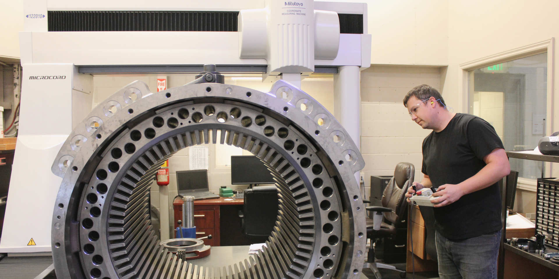 CMM Technician measuring a Cat Frame for final dimensions using  a Crystal Apex CMM at the Piper Lane location in London Ontario.